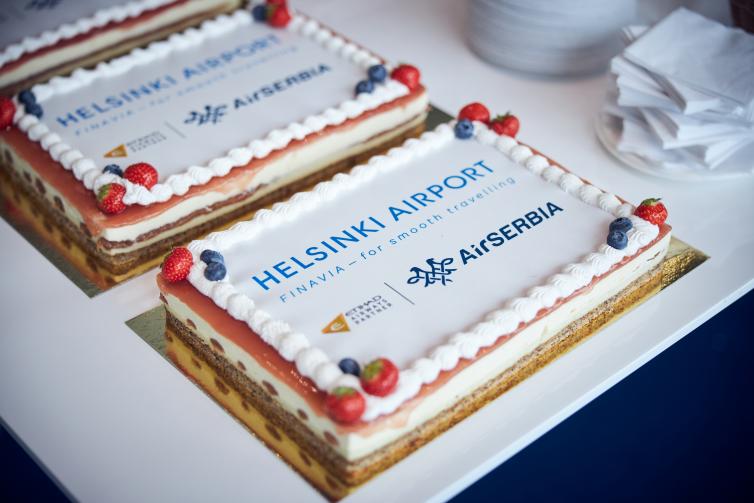 Two Air Serbia celebratory cakes and napkins on a side.