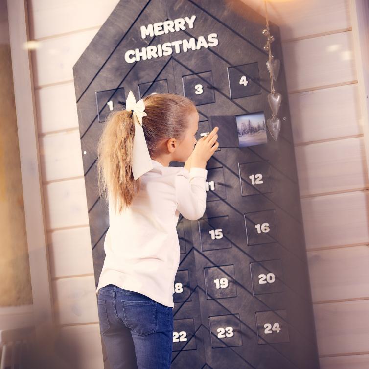 Girl checking christmas calendar.
