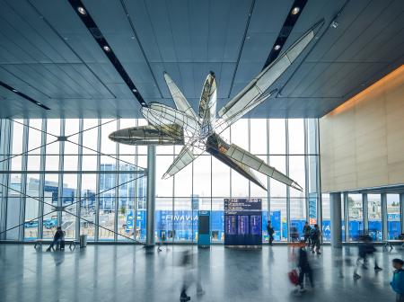 Large art sculpture hanging from the ceiling of Helsinki airport's east wing.