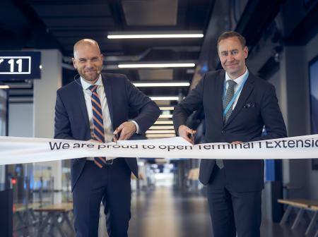 Two men cutting ribbon at T1 extension opening ceremony.