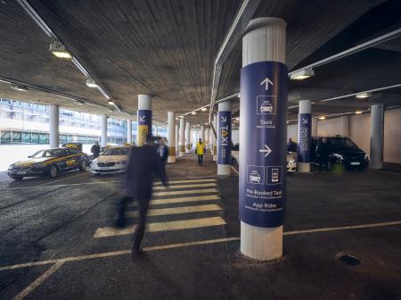 Passenger walking towards taxi rank.