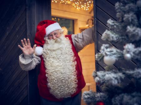 Santa claus at the door of the new Christmas cabin.