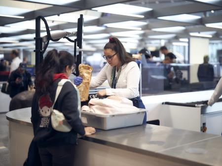Two women at a security control area at Helsinki Airport