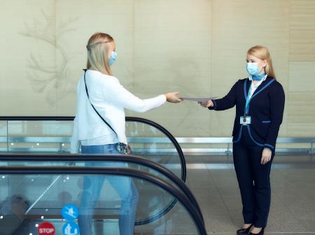 Matkustaja antaa paperin asiakasneuvojalle