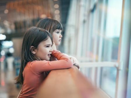 Little girls watching plains at Helsinki Airport.