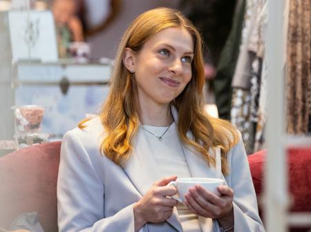 Matkustaja kahvilassa kahvikuppi kädessä