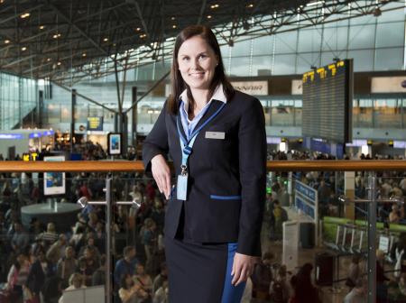 A woman posing to camera at departures lobby.