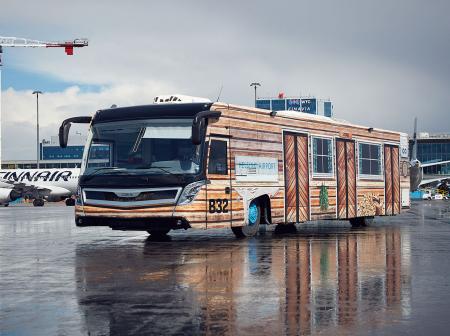 An airport buss painted to look as made out of wood.