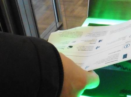 Boarding pass is being scanned to a automatic ticket check.