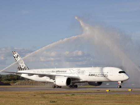 Fire trucks spraying water on an airplane.