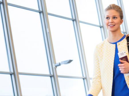 Passenger walking in airport gate area.