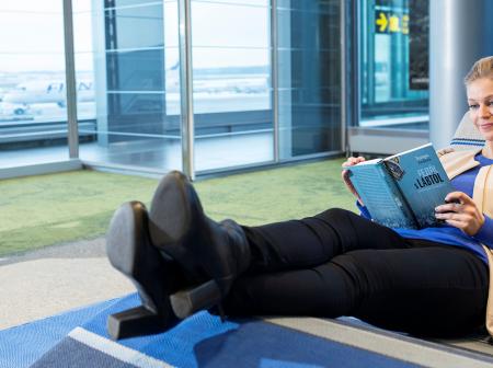 Passenger reading a book at Kainuu Lounge.
