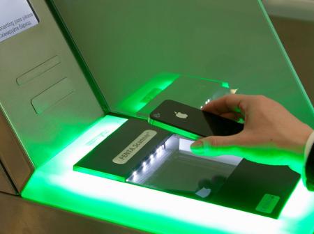 Boarding pass is being scanned to a automatic ticket check.