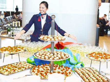 A table holding many different types of small foods and drinks.