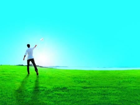 A man throws a paper plane.