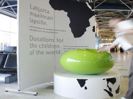 A green abstract artwork on a stand.