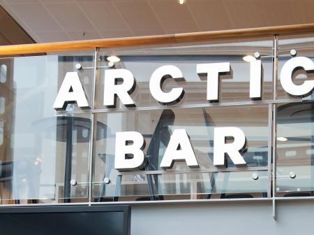 Arctic Bar sign on a glass railing 