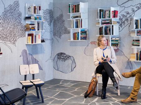 Passenger sitting at book swap.