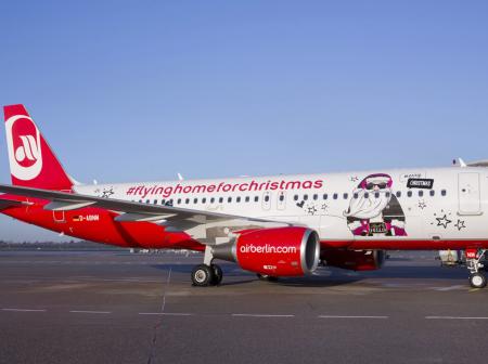 Christmas themed Airberlin airplane parked at gate.