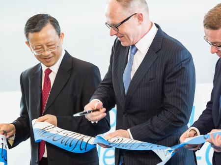 Three men at opening ceremony.