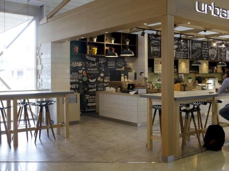 A man sitting at a table in front of a restaurant.