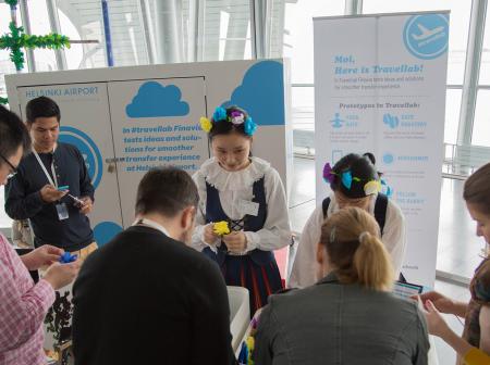 People making small decorations together.