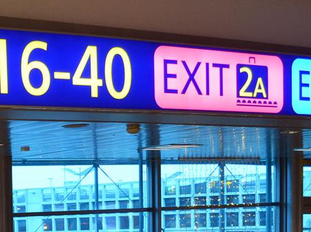 Exit signs at Helsinki Airport.