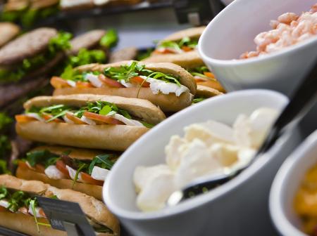 Sandwitches and sallads on table.