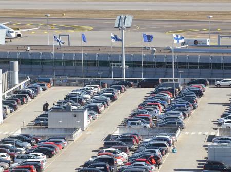 Cars parked at rooftop parking lot.
