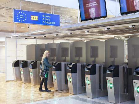 Woman going through automated passport control.