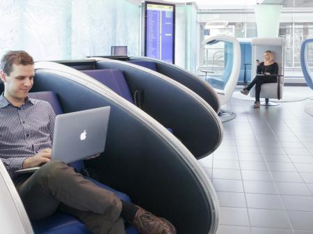 A man using laptop at a lounge.