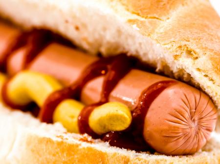 Close-up of a hot dog with mustard and ketchup.