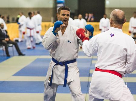 Two men boxing on a tatami.