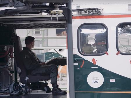 A man sitting inside a helicopter.