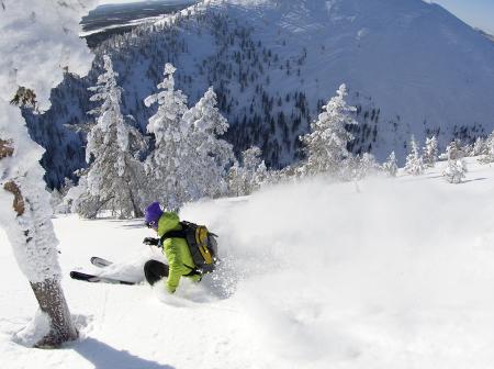 Person skiing down slopes.