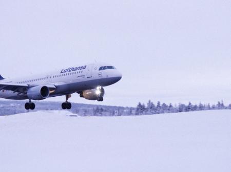 Lufthansa airplane taking off during winter.