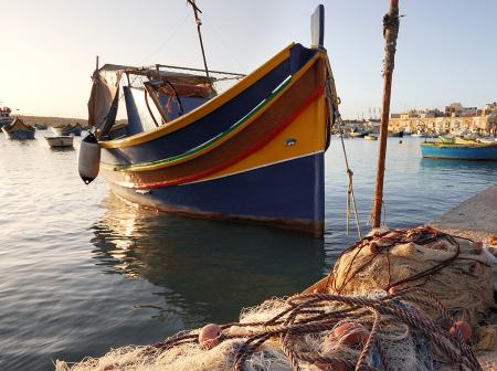 Colorful fishing boat at marina in Malta.