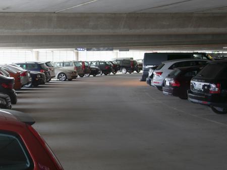 Multiple of cars parked in a parking hall.