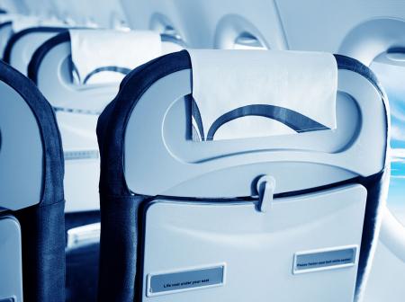 Backside of the seats in an airplane.