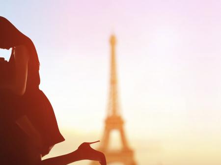 Couple being romantic in Paris with Eiffel Tower in the background.
