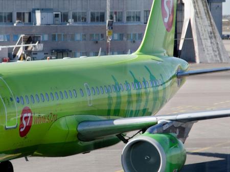 A green airplane at airport.
