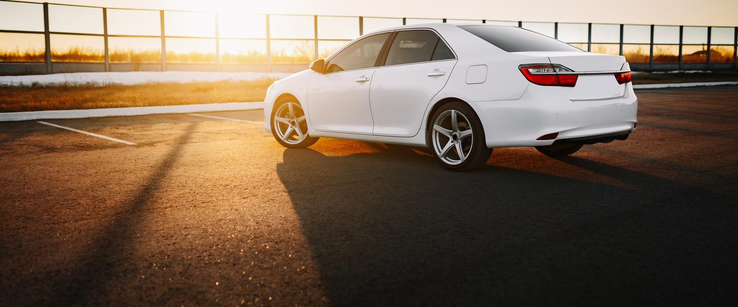 White car in parking area.