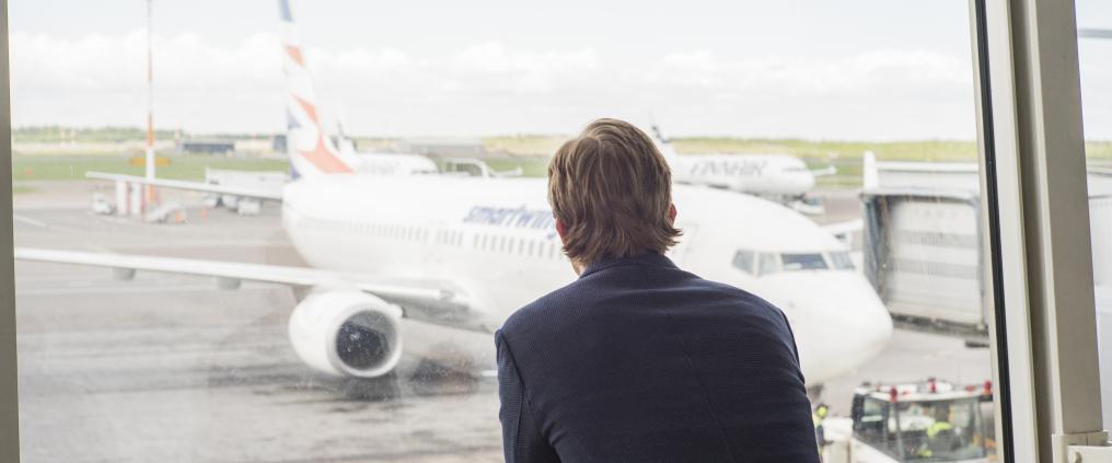 Businessman watching airplanes