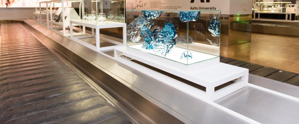 Fragile Water exhibition glass display cabinets at Helsinki airport 2B baggage claim.