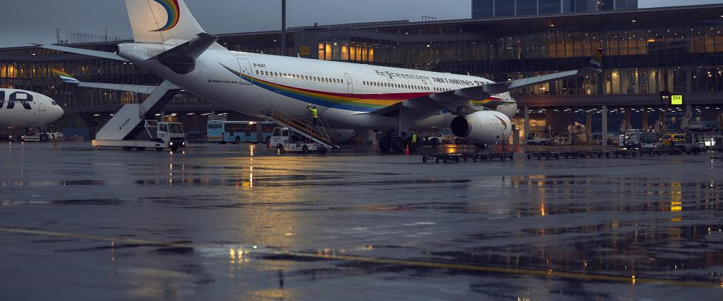 Tibet Airlines airplane at airport on a cloudy day.