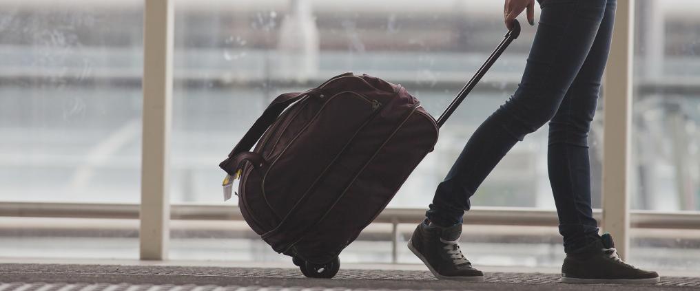 A passenger walking with luggage