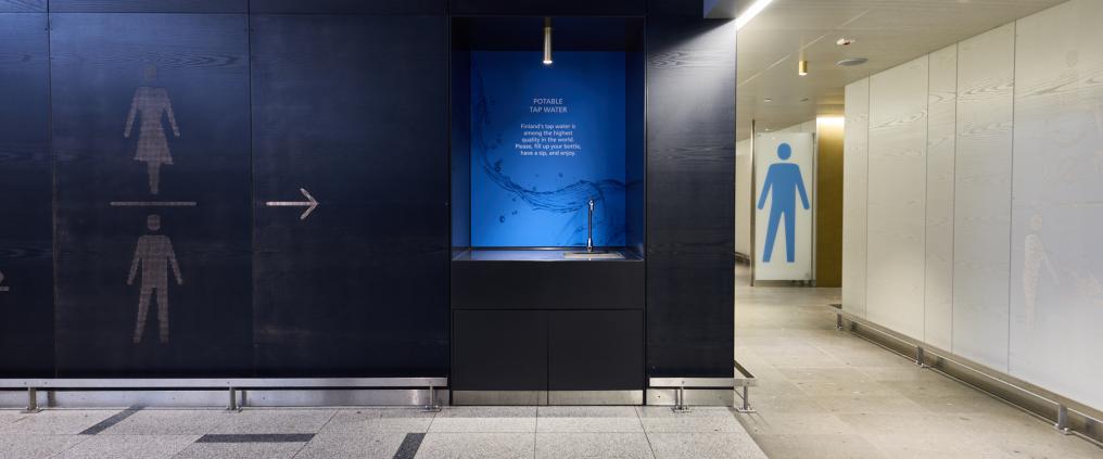 Passenger is taking water from water machine