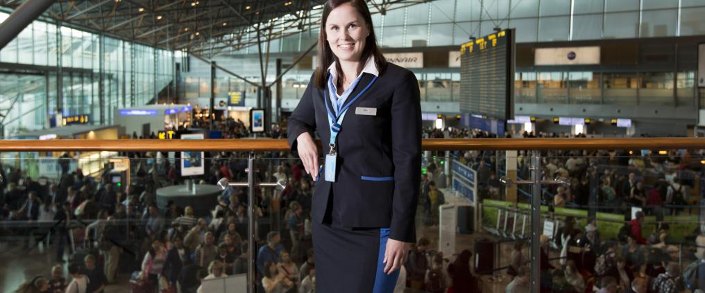 A woman posing to camera at departures lobby.