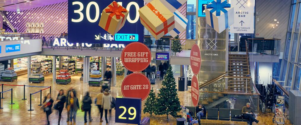 Helsinki airport gate area with large Christmas decorations.
