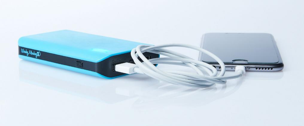 Power bank charging smartphone.
